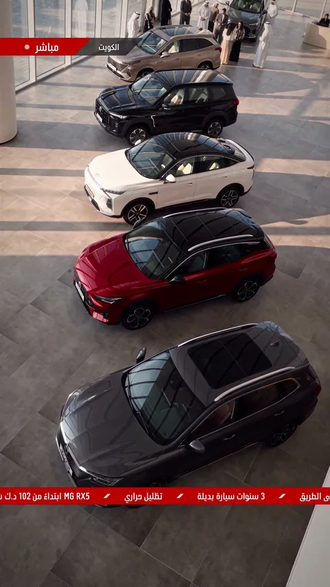 خمس سيارات SUV بالبيج والأسود والأبيض والأحمر والرمادي الداكن، مصفوفة بشكل مائل على أرضية معرض يدخلها الضوء، من الأعلى